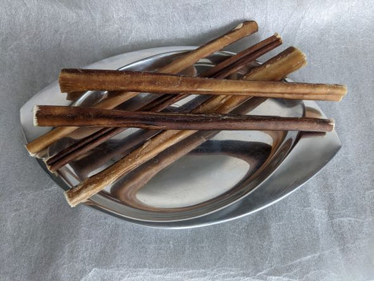Six ultra premium low odor bully sticks displayed on a silver platter.