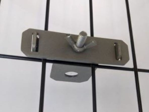 Image of the Zilla Kennel Clamp attached to the side of a crate.. The clamp is stainless steel.