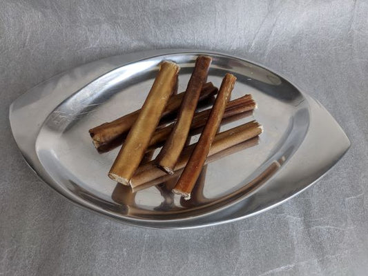 Six bully sticks, six inches long, ultra premium and low odor displaed on a silver platter.