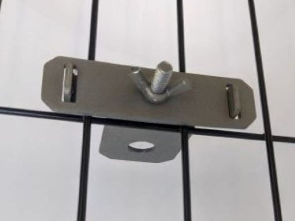 Image of the Zilla Kennel Clamp attached to the side of a crate.. The clamp is stainless steel. 